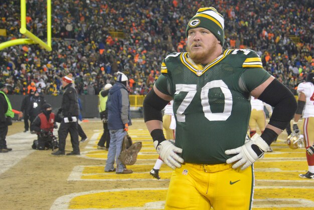 Jan 5, 2014; Green Bay, WI, USA;   Green Bay Packers guard T.J. Lang (70) walks off the field after the San Francisco 49ers beat the Packers 23-20 during the 2013 NFC wild card playoff football game at Lambeau Field. Mandatory Credit: Benny Sieu-USA TODAY Sports