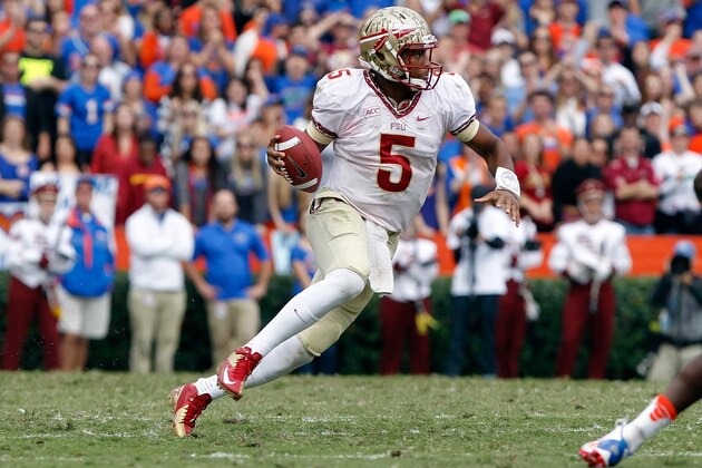 Nov 30, 2013; Gainesville, FL, USA; Florida State Seminoles quarterback Jameis Winston (5) runs out of the pocket against the Florida Gators during the second quarter at Ben Hill Griffin Stadium. Mandatory Credit: Kim Klement-USA TODAY Sports