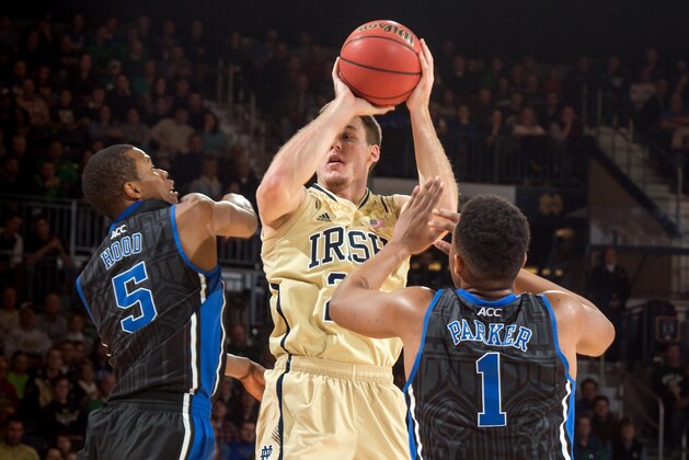 Jan 4, 2014; South Bend, IN, USA; Notre Dame Fighting Irish guard Pat Connaughton (24) passes the ball as Duke Blue Devils forward Rodney Hood (5) and forward Jabari Parker (1) defend in the first half at the Purcell Pavilion. Mandatory Credit: Matt Cashore-USA TODAY Sports