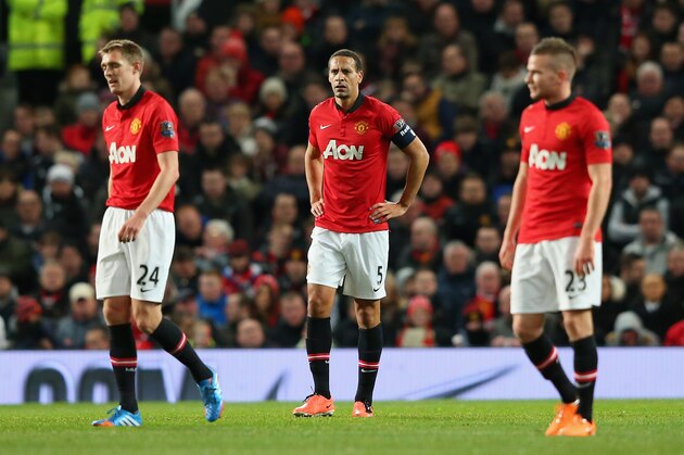 MANCHESTER, ENGLAND - JANUARY 05:  Rio Ferdinand of Manchester United and his team-mates react after conceding the first goal during the FA Cup with Budweiser Third round match between Manchester United and Swansea City at Old Trafford on January 5, 2014 in Manchester, England.  (Photo by Alex Livesey/Getty Images)