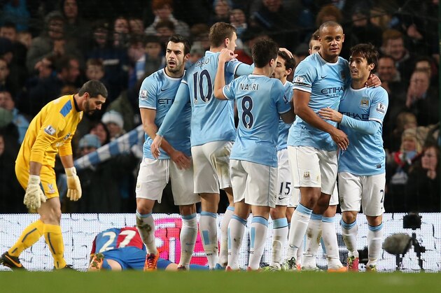 MANCHESTER, ENGLAND - DECEMBER 28:  Edin Dzeko of Manchester City is congratulated by his team-mates after scoring the opening goal during the Barclays Premier League match between Manchester City and Crystal Palace at the Etihad Stadium on December 28, 2013 in Manchester, England.  (Photo by Jan Kruger/Getty Images)