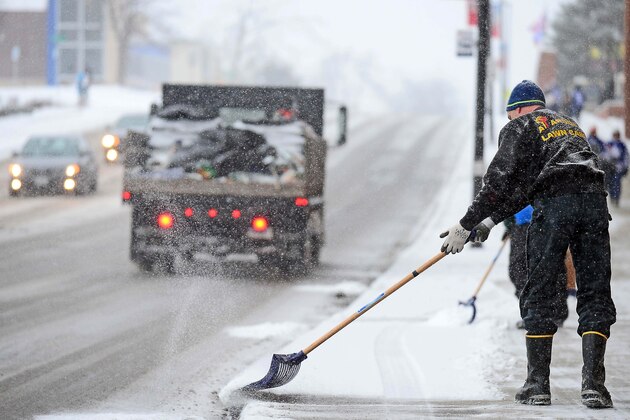 Jan 1, 2014; Ann Arbor, MI, USA; A maintenance member shovels snow outside of Michigan Stadium prior to the2014 Winter Classic hockey game between the Detroit Red Wings and the Toronto Maple Leafs. Mandatory Credit: Andrew Weber-USA TODAY Sports