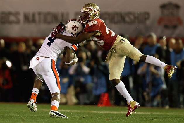 PASADENA, CA - JANUARY 06:  Wide receiver Quan Bray #4 of the Auburn Tigers is tackled by defensive back Lamarcus Joyner #20 of the Florida State Seminoles during the 2014 Vizio BCS National Championship Game at the Rose Bowl on January 6, 2014 in Pasadena, California.  (Photo by Jeff Gross/Getty Images)