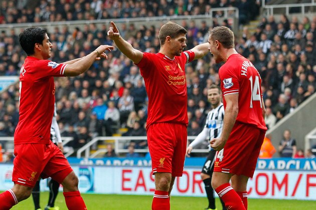 NEWCASTLE-UPON-TYNE, ENGLAND - OCTOBER 19: Steven Gerrard (C) of Liverpool celebrates after scoring his 100th Premier League goal and his team's first with team-mates Jordan Henderson (R) and Luis Suarez during the Barclays Premier League match between Newcastle United and Liverpool at St James' Park on October 19, 2013 in Newcastle-Upon-Tyne, England. (Photo by Paul Thomas/Getty Images)
