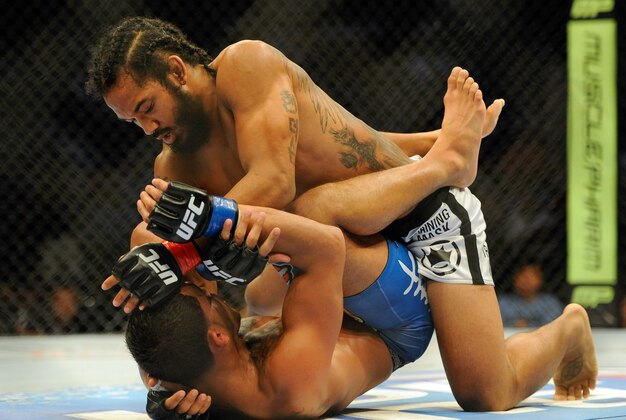 Aug 31, 2013; Milwaukee, WI, USA;  Benson Henderson (top) fights Anthony Pettis during the UFC-164 bout at BMO Harris Bradley Center. at BMO Harris Bradley Center. Mandatory Credit: Benny Sieu-USA TODAY Sports