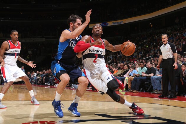 WASHINGTON, DC - JANUARY 1: John Wall #2 of the Washington Wizards drives against Jose Calderon #8 of the Dallas Mavericks during the game at the Verizon Center on January 1, 2014 in Washington, DC. NOTE TO USER: User expressly acknowledges and agrees that, by downloading and or using this photograph, User is consenting to the terms and conditions of the Getty Images License Agreement. Mandatory Copyright Notice: Copyright 2014 NBAE (Photo by Ned Dishman/NBAE via Getty Images)