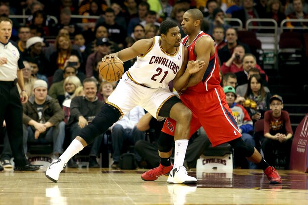 CLEVELAND, OH - DECEMBER 26: Andrew Bynum #21 of the Cleveland Cavaliers handles the ball against Al Horford #15 of the Atlanta Hawks in the first half at Quicken Loans Arena on December 26, 2013 in Cleveland, Ohio.  NOTE TO USER: User expressly acknowledges and agrees that, by downloading and/or using this photograph, user is consenting to the terms and conditions of the Getty Images License Agreement.  (Photo by Mike Lawrie/Getty Images)