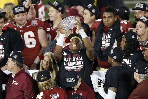 Jan 6, 2014; Pasadena, CA, USA; Florida State Seminoles quarterback Jameis Winston (5) holds the Coaches Trophy after defeating the Auburn Tigers 34-31 in the 2014 BCS National Championship game at the Rose Bowl.  Mandatory Credit: Kelvin Kuo-USA TODAY Sports