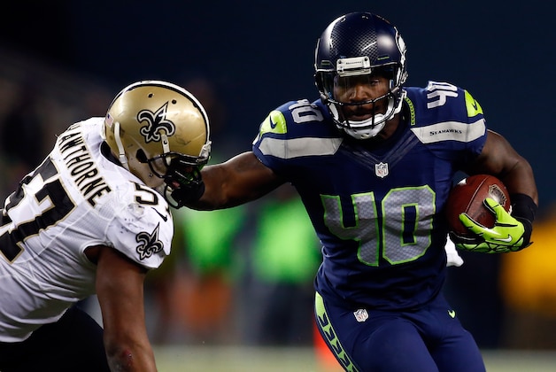 SEATTLE, WA - DECEMBER 02: Fullback Derrick Coleman #40 of the Seattle Seahawks carries the ball as outside linebacker David Hawthorne #57 of the New Orleans Saints defends during a game at CenturyLink Field on December 2, 2013 in Seattle, Washington.  (Photo by Jonathan Ferrey/Getty Images)
