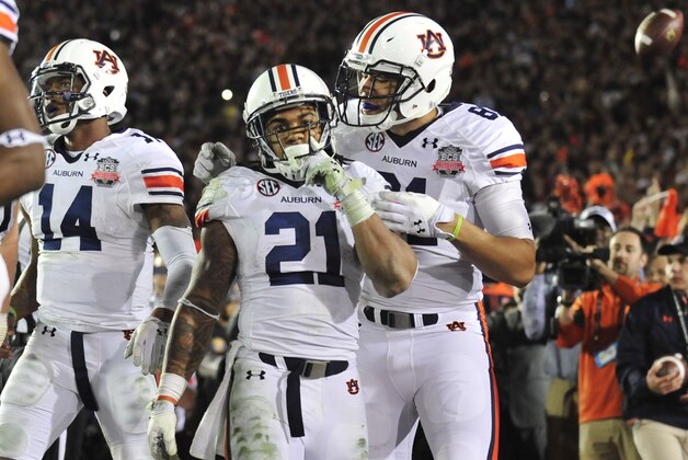Jan 6, 2014; Pasadena, CA, USA; Auburn Tigers running back Tre Mason (21) celebrates his touchdown with tight end C.J. Uzomah (81) during the second half of the 2014 BCS National Championship game against the Florida State Seminoles at the Rose Bowl.  Mandatory Credit: Gary A. Vasquez-USA TODAY Sports