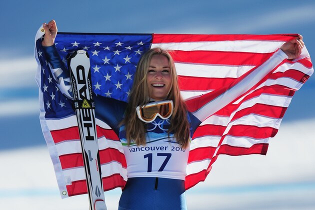 WHISTLER, BC - FEBRUARY 20:  Bronze medalist Lindsey Vonn of the United States celebrates with the American flag after the women's alpine skiing Super-G on day nine of the Vancouver 2010 Winter Olympics at Whistler Creekside on February 20, 2010 in Whistler, Canada.  (Photo by Shaun Botterill/Getty Images)