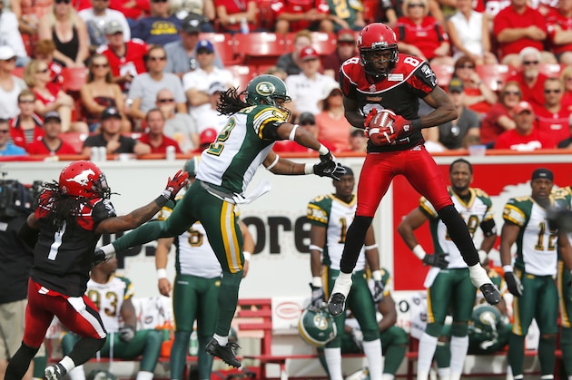 CALGARY, CANADA - SEPTEMBER 2: Fred Bennett #8 of the Calgary Stampeders intercepts a pass intended for Fred Stamps #2 of the Edmonton Eskimos in the first half of their CFL football game September 2, 2013 in Calgary, Alberta, Canada. (Photo by Todd Korol/Getty Images)