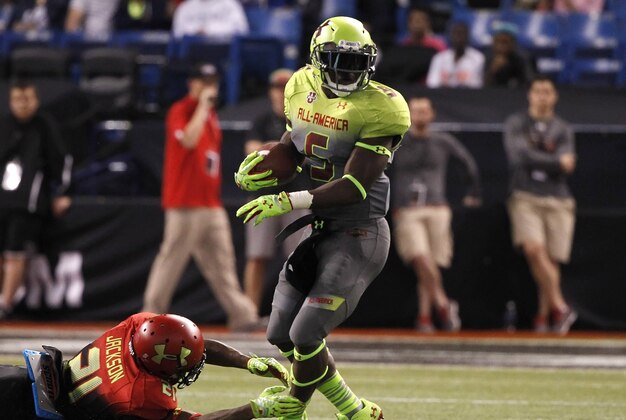 Jan 2, 2014; St. Petersburg, FL, USA;  Team Nitro cornerback Jabrill Peppers (5) runs with the ball as Team Hightlight cornerback  Adoree Jackson (21) defends during the second half at Tropicana Field. Team Highlight defeated the Team Nitro 31-21. Mandatory Credit: Kim Klement-USA TODAY Sports