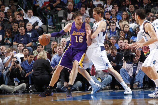 DALLAS, TX - JANUARY 7: Pau Gasol #16 of the Los Angeles Lakers controls the ball against Dirk Nowitzki #41 of the Dallas Mavericks on January 7, 2014 at the American Airlines Center in Dallas, Texas. NOTE TO USER: User expressly acknowledges and agrees that, by downloading and or using this photograph, User is consenting to the terms and conditions of the Getty Images License Agreement. Mandatory Copyright Notice: Copyright 2014 NBAE (Photo by Glenn James/NBAE via Getty Images)