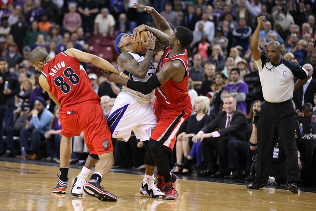 Jan 7, 2014; Sacramento, CA, USA; Portland Trail Blazers small forward Nicolas Batum (88) and shooting guard Wesley Matthews (2) surround Sacramento Kings point guard Isaiah Thomas (22) for a foul by Batum during the fourth quarter at Sleep Train Arena. The Sacramento Kings defeated the Portland Trail Blazers 123-119. Mandatory Credit: Kelley L Cox-USA TODAY Sports