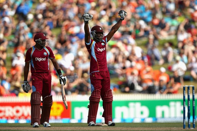 HAMILTON, NEW ZEALAND - JANUARY 08:  Kirk Edwards of the West Indies (R) celebrates his century with  Dwayne Bravo (L) during game five of the One Day International Series between New Zealand and the West Indies at Seddon Park on January 8, 2014 in Hamilton, New Zealand.  (Photo by Phil Walter/Getty Images)