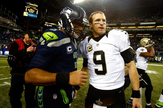 SEATTLE, WA - DECEMBER 02:  Quarterback Russell Wilson #3 of the Seattle Seahawks and quarterback Drew Brees #9 of the New Orleans Saints meet on the field after the Seattle Seahawks defeated the New Orleans Saints 34-7 in a game at CenturyLink Field on December 2, 2013 in Seattle, Washington.  (Photo by Jonathan Ferrey/Getty Images)