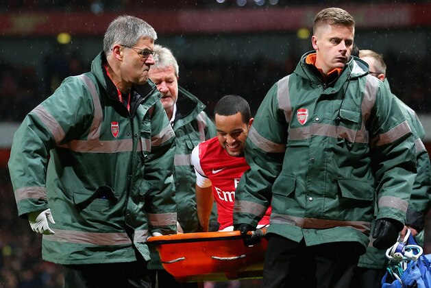 LONDON, ENGLAND - JANUARY 04:  Theo Walcott of Arsenal is stretchered off the pitch during the Budweiser FA Cup third round match between Arsenal and Tottenham Hotspur at Emirates Stadium on January 4, 2014 in London, England. at Emirates Stadium on January 4, 2014 in London, England.  (Photo by Clive Rose/Getty Images)