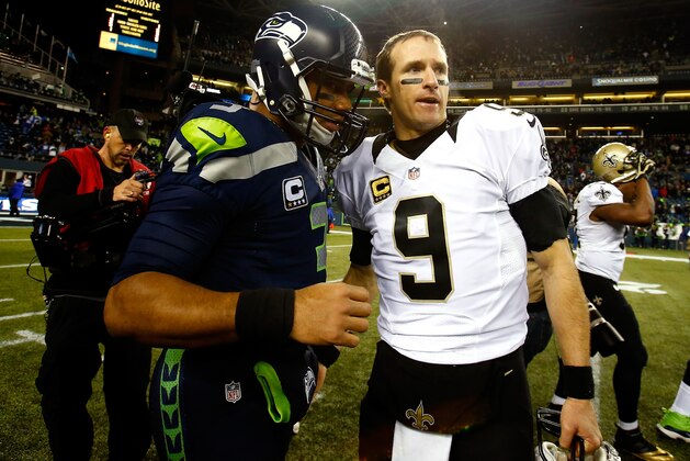 SEATTLE, WA - DECEMBER 02:  Quarterback Russell Wilson #3 of the Seattle Seahawks and quarterback Drew Brees #9 of the New Orleans Saints meet on the field after the Seattle Seahawks defeated the New Orleans Saints 34-7 in a game at CenturyLink Field on December 2, 2013 in Seattle, Washington.  (Photo by Jonathan Ferrey/Getty Images)