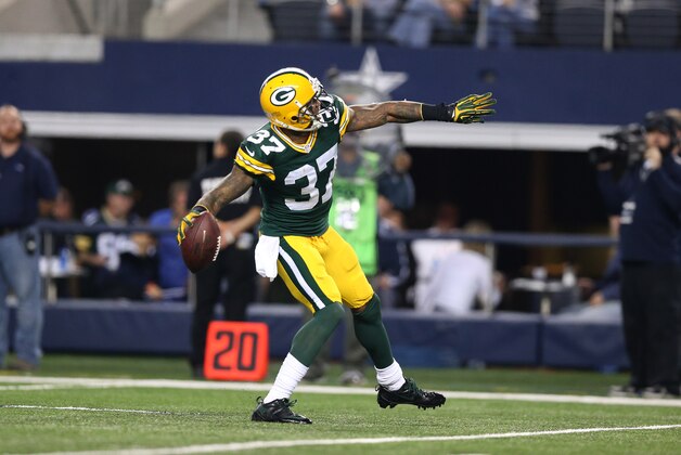 Dec 15, 2013; Arlington, TX, USA; Green Bay Packers cornerback Sam Shields (37) throws the ball into the stands after an interception in the fourth quarter against Dallas Cowboys receiver Miles Austin (19) at AT&T Stadium. The Packers beat the Cowboys 37-36. Mandatory Credit: Matthew Emmons-USA TODAY Sports