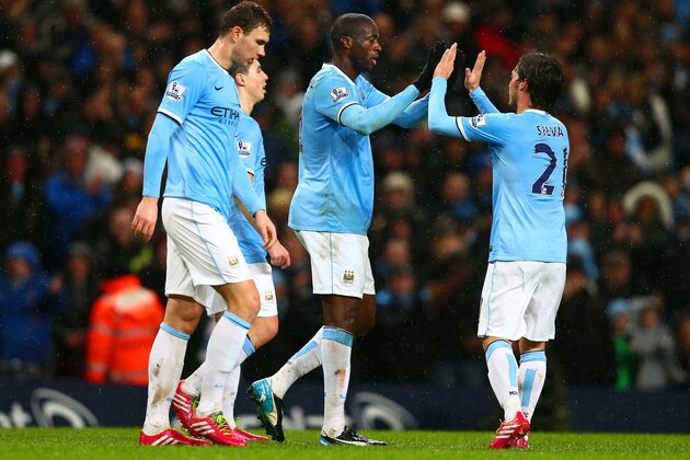 MANCHESTER, ENGLAND - JANUARY 08:  Yaya Toure of Manchester City celebrates scoring their third goal with David Silva of Manchester City during the Capital One Cup Semi-Final first leg match between Manchester City and West Ham United at Etihad Stadium on January 8, 2014 in Manchester, England.  (Photo by Clive Mason/Getty Images)