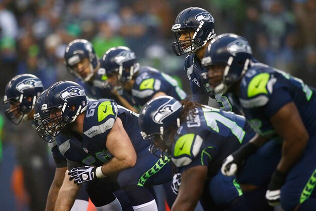 SEATTLE - DECEMBER 22:  Russell Wilson #3 of the Seattle Seahawks calls a play against the Arizona Cardinals on December 22, 2013 at CenturyLink Field in Seattle, Washington.  (Photo by Jonathan Ferrey/Getty Images)