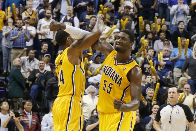 Dec 20, 2013; Indianapolis, IN, USA; Indiana Pacers forward Paul George (24) celebrates with center Roy Hibbert (55) after a reverse dunk against the Houston Rockets at Bankers Life Fieldhouse. Indiana defeats Houston 114-81. Mandatory Credit: Brian Spurlock-USA TODAY Sports