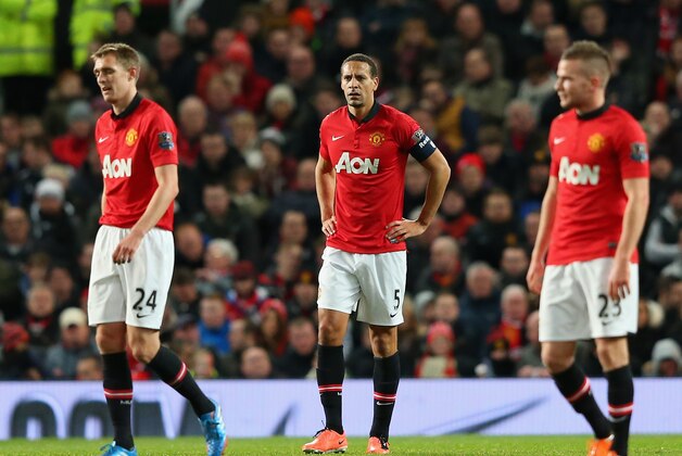 MANCHESTER, ENGLAND - JANUARY 05:  Rio Ferdinand of Manchester United and his team-mates react after conceding the first goal during the FA Cup with Budweiser Third round match between Manchester United and Swansea City at Old Trafford on January 5, 2014 in Manchester, England.  (Photo by Alex Livesey/Getty Images)