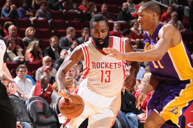 HOUSTON, TX - JANUARY 8:  James Harden #13 of the Houston Rockets drives against Wesley Johnson #11 of the Los Angeles Lakers on January 8, 2014 at the Toyota Center in Houston, Texas. NOTE TO USER: User expressly acknowledges and agrees that, by downloading and or using this photograph, User is consenting to the terms and conditions of the Getty Images License Agreement. Mandatory Copyright Notice: Copyright 2014 NBAE (Photo by Bill Baptist/NBAE via Getty Images)