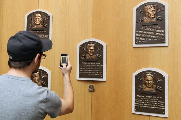 COOPERSTOWN, NY - JULY 24:  A patron of the Baseball Hall of Fame and Museum takes a photograph of the plaques of inducted members during induction weekend on July 24, 2010 in Cooperstown, New York.  (Photo by Jim McIsaac/Getty Images)