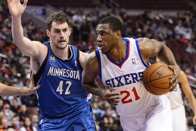 Jan 6, 2014; Philadelphia, PA, USA; Philadelphia 76ers forward Thaddeus Young (21) is defended by Minnesota Timberwolves forward Kevin Love (42) during the first quarter at the Wells Fargo Center. Mandatory Credit: Howard Smith-USA TODAY Sports