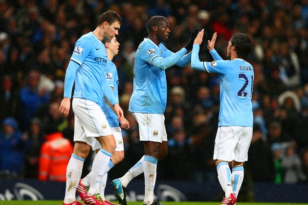 MANCHESTER, ENGLAND - JANUARY 08:  Yaya Toure of Manchester City celebrates scoring their third goal with David Silva of Manchester City during the Capital One Cup Semi-Final first leg match between Manchester City and West Ham United at Etihad Stadium on January 8, 2014 in Manchester, England.  (Photo by Clive Mason/Getty Images)
