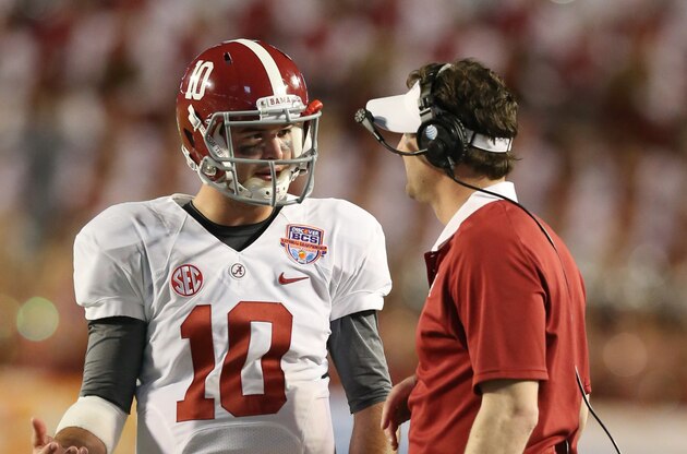 Jan 7, 2013; Miami, FL, USA; Alabama Crimson Tide quarterback A.J. McCarron (10) talks with quarterbacks coach Doug Nussmeier during a timeout against the Notre Dame Fighting Irish during the 2013 BCS Championship game at Sun Life Stadium. Alabama won 42-14.  Mandatory Credit: Matthew Emmons-USA TODAY Sports