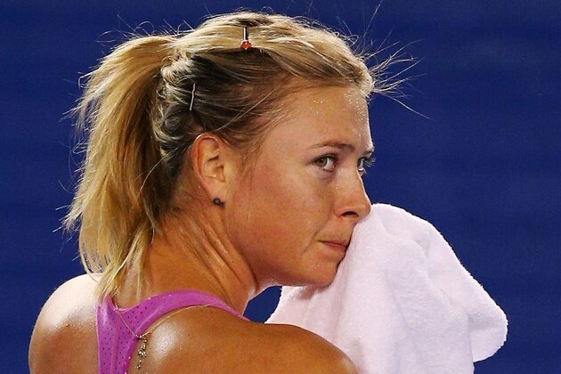 MELBOURNE, AUSTRALIA - JANUARY 06:  Maria Sharapova of Russia wipes sweat of her face during practice ahead of the 2014 Australian Open at Melbourne Park on January 6, 2014 in Melbourne, Australia.  (Photo by Michael Dodge/Getty Images)