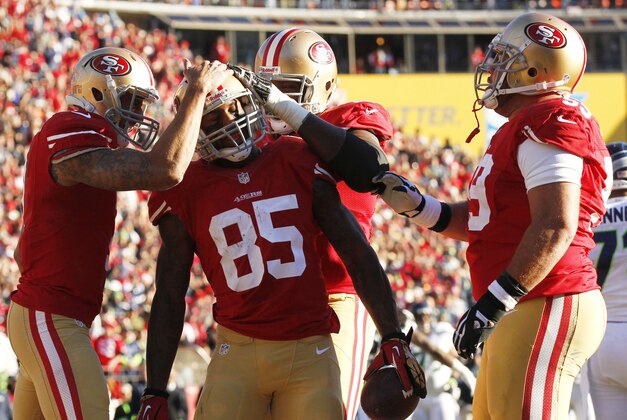Dec 8, 2013; San Francisco, CA, USA; San Francisco 49ers tight end Vernon Davis (85) is congratulated by teammates after catching a touchdown pass against the Seattle Seahawks in the second quarter at Candlestick Park. Mandatory Credit: Cary Edmondson-USA TODAY Sports