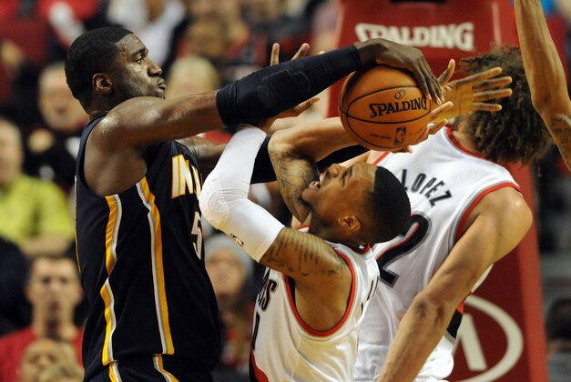 Dec 2, 2013; Portland, OR, USA; Indiana Pacers center Roy Hibbert (55) blocks the shot of Portland Trail Blazers point guard Damian Lillard (0) during the fourth quarter of the game at the Moda Center. The Blazers won the game 106-102. Mandatory Credit: Steve Dykes-USA TODAY Sports