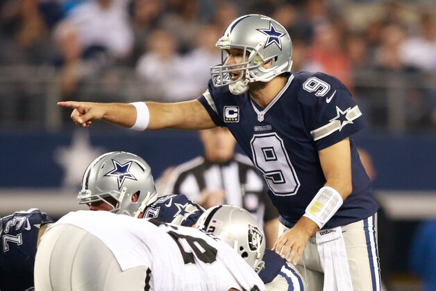 Nov 28, 2013; Arlington, TX, USA; Dallas Cowboys quarterback Tony Romo (9) points at the Oakland Raiders defense during a NFL football game on Thanksgiving at AT&T Stadium. Dallas beat Oakland 31-24. Mandatory Credit: Tim Heitman-USA TODAY Sports