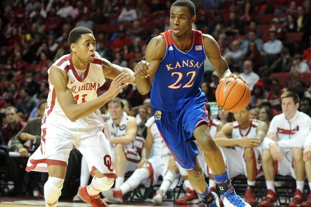 Jan 8, 2014; Norman, OK, USA; Kansas Jayhawks guard Andrew Wiggins (22) handles the ball while being guarded by Oklahoma Sooners guard Isaiah Cousins (11) during the first half at Lloyd Noble Center. Mandatory Credit: Mark D. Smith-USA TODAY Sports