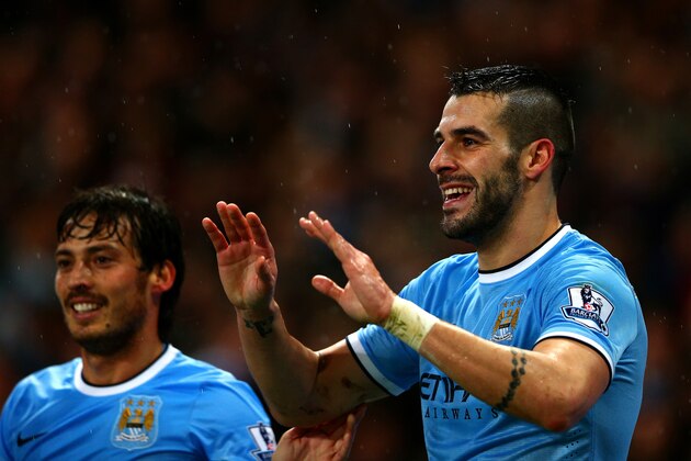 MANCHESTER, ENGLAND - JANUARY 08:  Alvaro Negredo of Manchester City celebrates scoring his second goal with David Silva of Manchester City during the Capital One Cup Semi-Final first leg match between Manchester City and West Ham United at Etihad Stadium on January 8, 2014 in Manchester, England.  (Photo by Clive Mason/Getty Images)