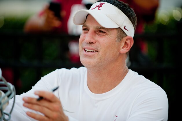 Aug 4, 2013; Tuscaloosa, AL, USA; Alabama Crimson Tide defensive coordinator Doug Nussmeier signs autographs following practice at Bryant Denny Stadium. Mandatory Credit: Kevin Liles-USA TODAY Sports
