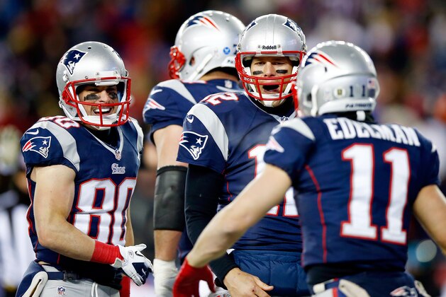 FOXBORO, MA - NOVEMBER 24: Quarterback Tom Brady #12 of the New England Patriots celebrates with wide receiver Julian Edelman #11 against the Denver Broncos during a game at Gillette Stadium on November 24, 2013 in Foxboro, Massachusetts.  (Photo by Jared Wickerham/Getty Images)