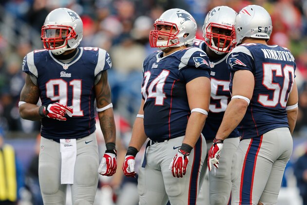 FOXBORO, MA - DECEMBER 8:  Jamie Collins #91, Chris Jones #94, Chandler Jones #95, and Rob Ninkovich #50 of the New England Patriots confer during a game with Cleveland Browns at Gillette Stadium on December 8, 2013 in Foxboro, Massachusetts. (Photo by Jim Rogash/Getty Images)