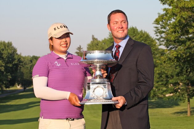 PITTSFORD, NY - JUNE 10: Shanshan Feng of China and LPGA commissioner Michael Whan hold the championship trophy after the final round the Wegmans LPGA Championship at Locust Hill Country Club on June 10, 2012 in Pittsford, New York. (Photo by Hunter Martin/Getty Images)