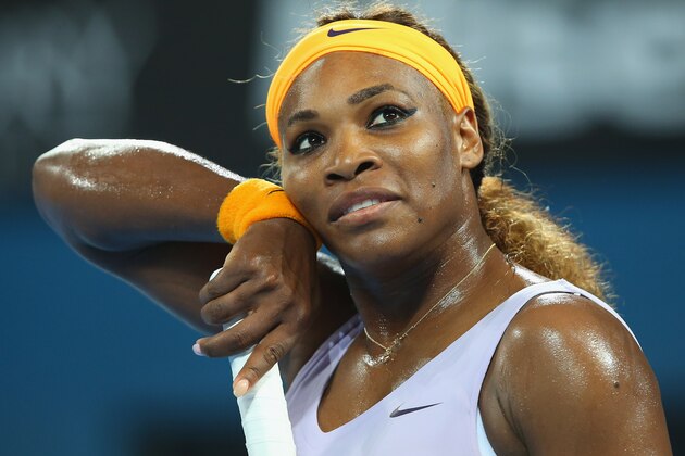 BRISBANE, AUSTRALIA - JANUARY 03:  Serena Williams of the USA wipes sweat off her face in her match against Maria Sharapova of Russia during day six of the 2014 Brisbane International at Queensland Tennis Centre on January 3, 2014 in Brisbane, Australia.  (Photo by Chris Hyde/Getty Images)