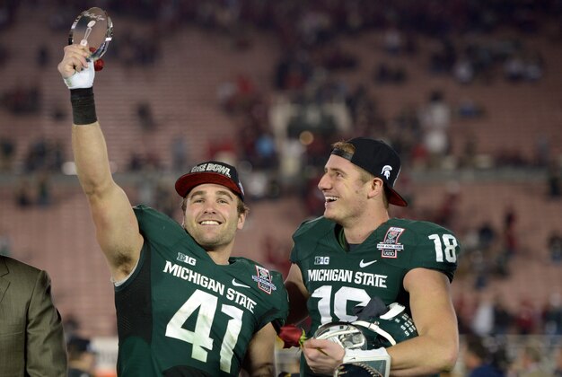 Jan 1, 2014; Pasadena, CA, USA; Michigan State Spartans linebacker Kyler Elsworth (41) and quarterback Connor Cook (18) celebrate after the 100th Rose Bowl against the Stanford Cardinal. Michigan State defeated Stanford 24-20. Mandatory Credit: Kirby Lee-USA TODAY Sports