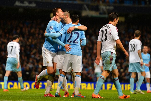 MANCHESTER, ENGLAND - JANUARY 08:  Edin Dzeko of Manchester City celebrates with team mates after socring their fifth goal during the Capital One Cup Semi-Final first leg match between Manchester City and West Ham United at Etihad Stadium on January 8, 2014 in Manchester, England.  (Photo by Shaun Botterill/Getty Images)