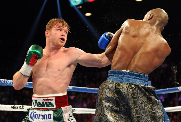 Sep 14, 2013; Las Vegas, NV, USA; Floyd Mayweather Jr. (blue gloves) and Canelo Alvarez battle it during their during their WBC and WBA super welterweight titles fight at MGM Grand Garden Arena. Mandatory Credit: Jayne Kamin-Oncea-USA TODAY Sports