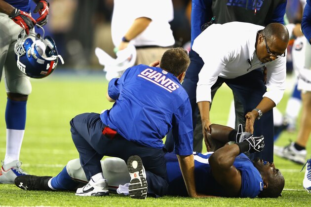 EAST RUTHERFORD, NJ - AUGUST 24:  Stevie Brown #27 of the New York Giants is in pain after injuring his leg after making an interception against  Geno Smith #7 of the New York Jets  during their pre season game at MetLife Stadium on August 24, 2013 in East Rutherford, New Jersey.  (Photo by Al Bello/Getty Images)