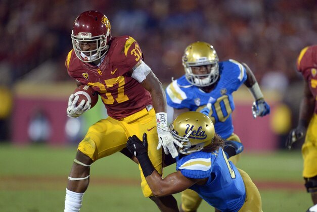 Nov 30, 2013; Los Angeles, CA, USA; Southern California Trojans tailback Javorious Allen (37) is defended by UCLA Bruins linebacker Eric Kendricks (6) at Los Angeles Memorial Coliseum. Mandatory Credit: Kirby Lee-USA TODAY Sports Nov 30, 2013; Los Angeles, CA, USA; Southern California Trojans tailback Javorious Allen (37) is defended by UCLA Bruins linebacker Eric Kendricks (6) at Los Angeles Memorial Coliseum. Mandatory Credit: Kirby Lee-USA TODAY Sports