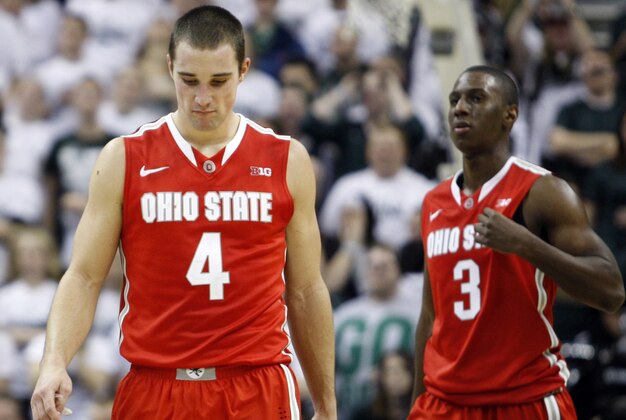 Jan 7, 2014; East Lansing, MI, USA; Ohio State Buckeyes guard Aaron Craft (4) and guard Shannon Scott (3) react during overtime against the Michigan State Spartans at Jack Breslin Student Events Center. Spartans beat the Buckeyes 72-68 in overtime. Mandatory Credit: Raj Mehta-USA TODAY Sports